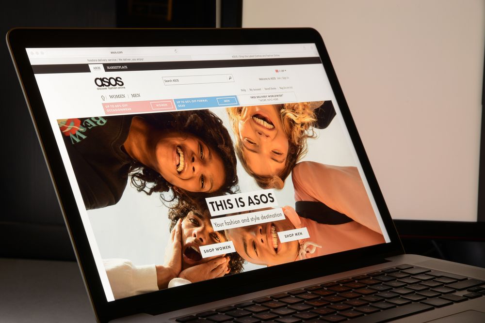 Laptop open showing Asos homepage