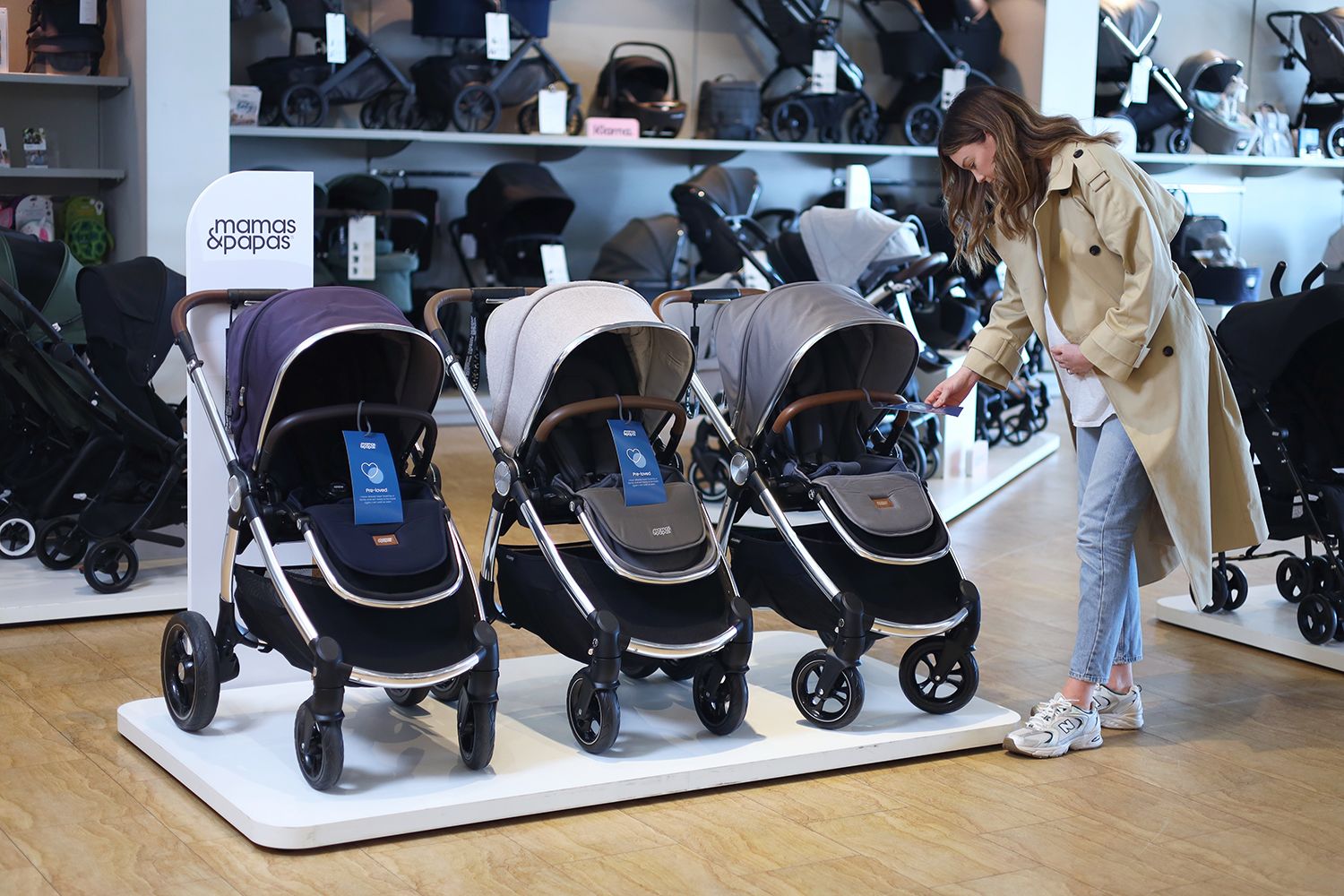 Woman looking at pushchairs in Mamas & Papas store