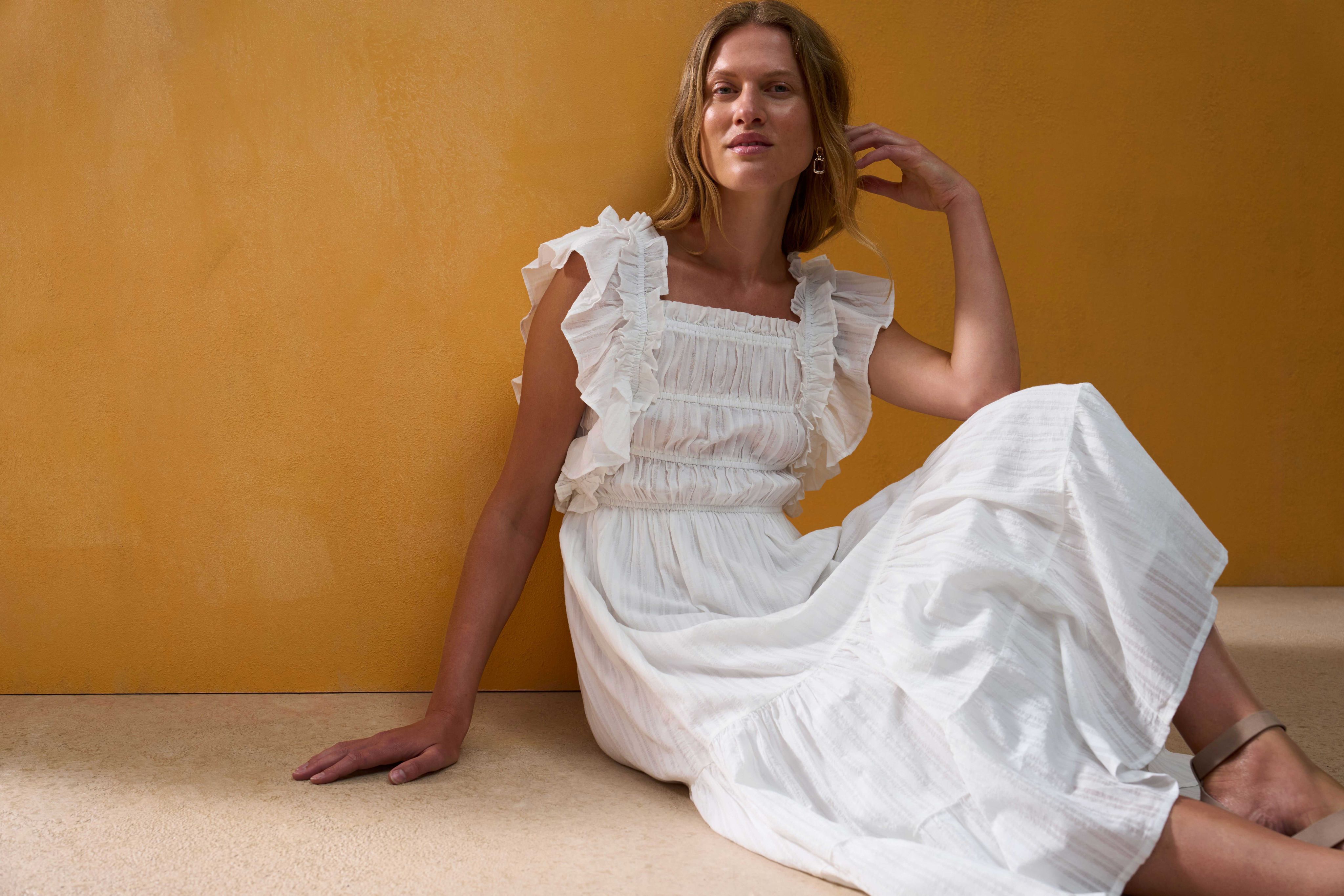 Female model sat on floor wearing white Matalan dress